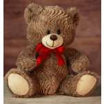 Brown teddy bear with a red ribbon bow