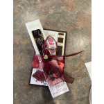 Two boxed chocolate bars tied together with a burgundy ribbon