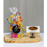 Gift bag of colorful wrapped milk chocolate squares with curling ribbons beside a florist business card.
