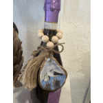 Decorated wine bottle with twine, wooden beads, and a hanging seagull ornament