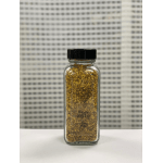 Small glass bottle filled with bee pollen granules