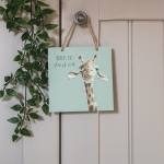 Decorative hanging sign with a giraffe illustration and faux trailing greenery