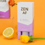 Boxed shower steamers with a yellow tulip and lemon on an orange background