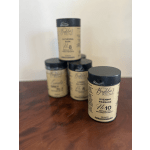 Set of four tan and black cylindrical canisters arranged on a wooden surface