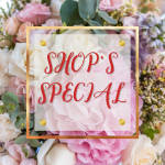 Pink and white floral arrangement with a "SHOP'S SPECIAL" sign