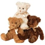 Three teddy bears stacked together with ribbon bows