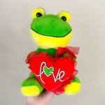 Plush frog holding a red heart with the word love