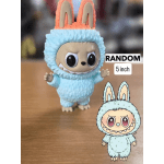 Small blue bunny-costumed figurine with large ears on a tabletop
