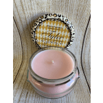 Pink candle in a glass jar with a patterned lid