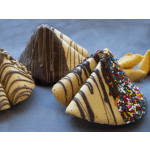 Assorted chocolate-dipped fortune cookies with nuts and sprinkles on a dark surface