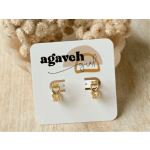 Gold heart-shaped earrings on a display card