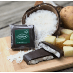 Chocolate-covered coconut candies with a coconut half and potato pieces