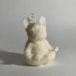 Small cream-colored dog figurine with a loop on top