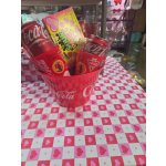 Coca-Cola cans and candy in a pink heart-patterned bucket
