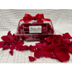 Clear plastic box with red rose petals and a red ribbon bow