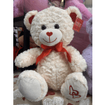Cream teddy bear with a red ribbon bow and heart details