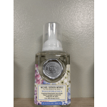 Bottle of foaming hand soap with floral label and clear pump
