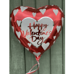 Heart-shaped red Valentine’s Day balloon with white hearts