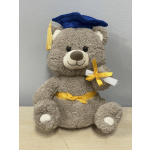 Plush teddy bear wearing a blue graduation cap and yellow ribbon