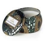 Decorative candle in a patterned tin with a matching lid
