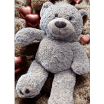 Gray plush teddy bear with metallic heart decorations