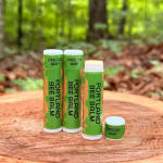 Four Oregon Mint lip balm tubes on a wooden surface