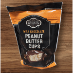 Bag of milk chocolate peanut butter cups on a wooden surface