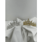 Two jeweled tiaras resting on white fabric