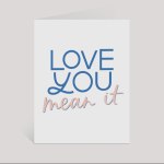 Greeting card reading "LOVE YOU mean it" in blue and pink text