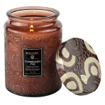 Amber glass candle jar with a patterned lid