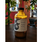 Amber bottle of fresh squeezed lotion on a table