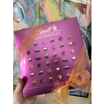 Box of Lindt mini pralines tied with a gold ribbon