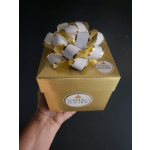 Gold Ferrero Rocher gift box with a white-and-gold bow