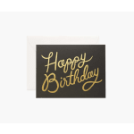 Black birthday card with gold script in front of a white envelope