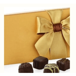 Gift box with a gold ribbon and assorted chocolates