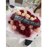 Bouquet of red and blush roses with a black anniversary ribbon