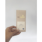 Hand holding a box of creamy milk chocolate