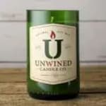 Green wine bottle with a large label on a wooden surface