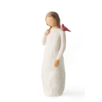 Carved figurine of a girl in a white dress with a red bird on her shoulder