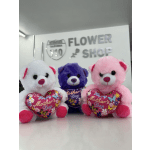 Three plush teddy bears holding heart-shaped Mother's Day pillows