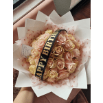 Bouquet of pale pink and cream roses with a birthday ribbon