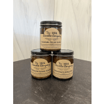Three labeled jar candles stacked in a pyramid on a table