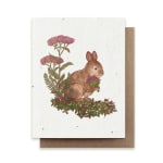 Greeting card with a rabbit holding flowers and pink blossoms