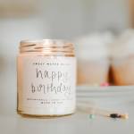 Birthday candle in a glass jar with a handwritten label