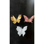 Three decorative butterfly ornaments in gold, pink, and white on a black background