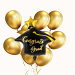 Gold graduation balloon bouquet with a black "Congrats Grad" balloon