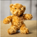 Small brown teddy bear with a ribbon bow