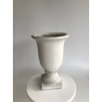 Empty white ceramic urn-style vase on a round pedestal