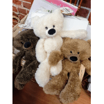 Three plush teddy bears in a basket, including white, brown, and tan bears