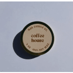Round tin candle labeled coffee house